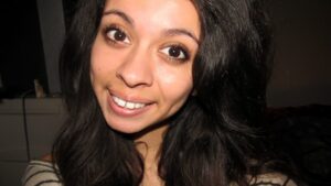 Frau mit braunen Augen blickt freundlich in die Kamera