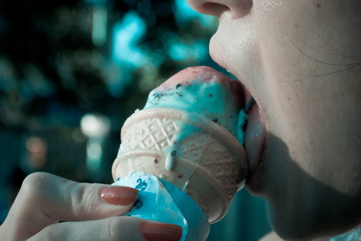 Gesicht von Frau im Profil leckt Eis