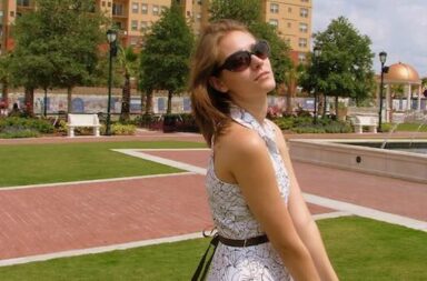 Frau macht Posing vor Springbrunnen