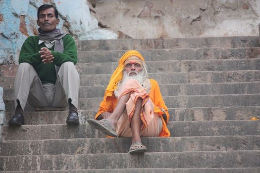 Alter Hindu mit safranfarbenem Turban auf Treppe