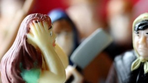 Plastikpuppen, Frau fasst sich an Kopf